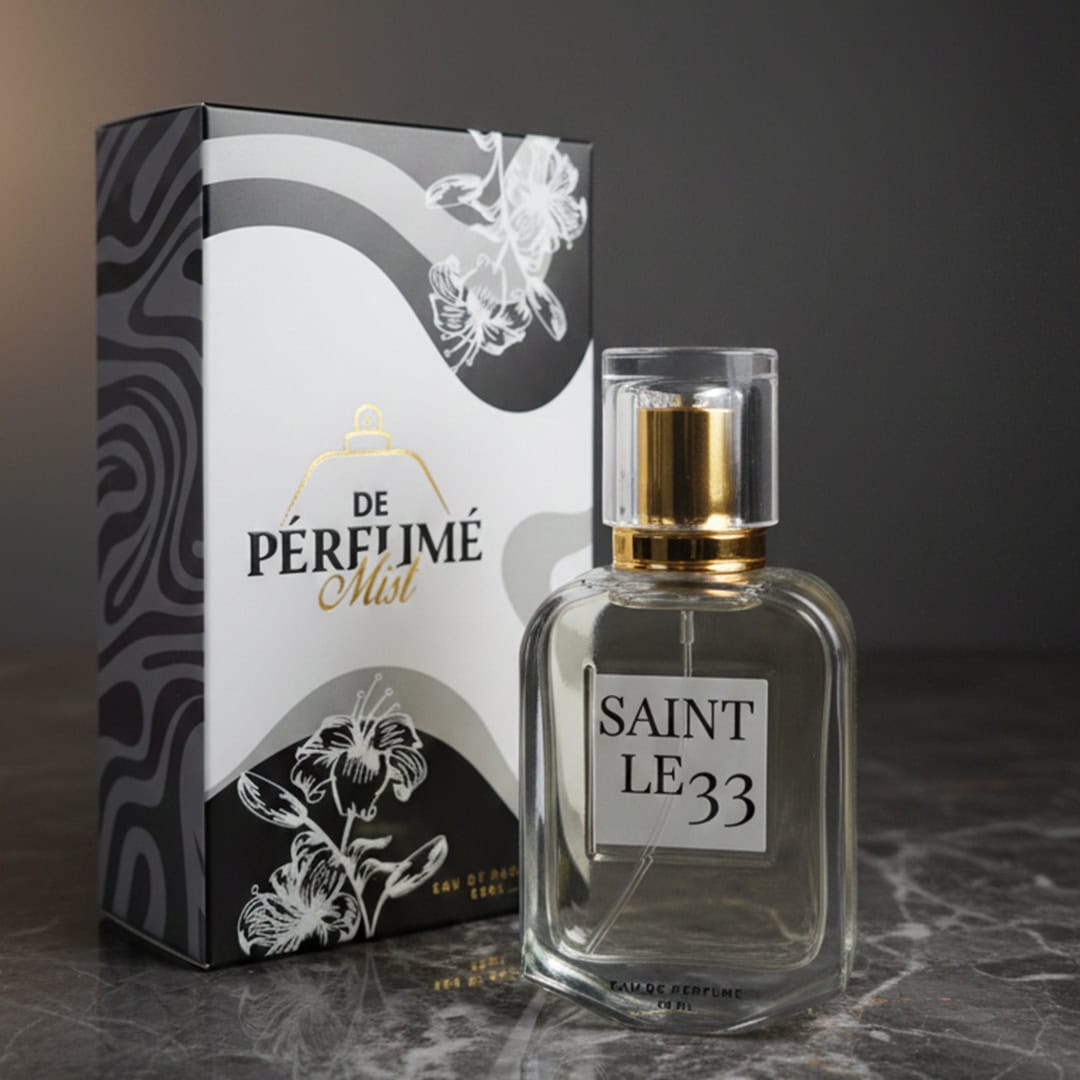 Elegant Saint Le 33 perfume mist with gold accents in a clear glass bottle.