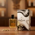 Roman Clout perfume mist bottle with packaging on wooden surface.